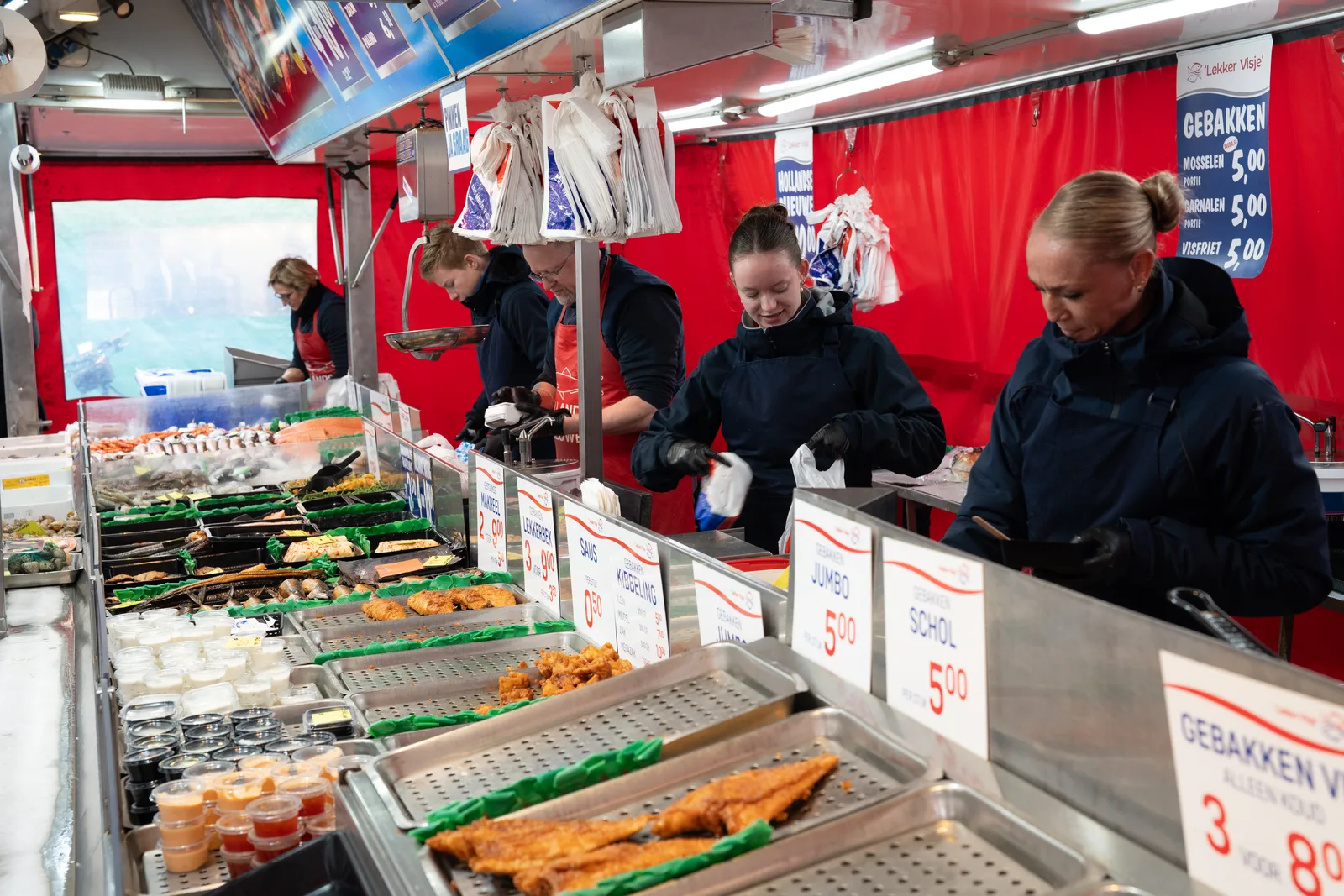 Fishmongers lining up to serve customers at the busiest time of the day